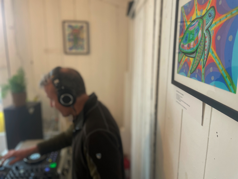 Cosmic Turtle DJing at Kommune, Totnes, under Turtle poster, 2023